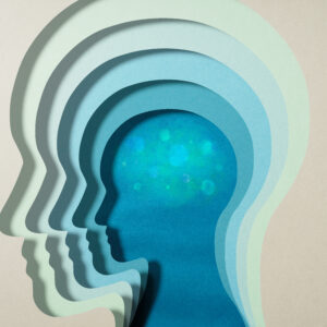 A blue paper cut out of a head with light effects